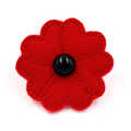 A red fabric poppy flower accessory with a glossy black button center, shown on a plain white background.