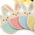 Set of bunny-shaped decoration with pastel colours and polka dot patterns on a white background.