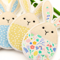 Three fabric bunny decorations with different patterns on a white background