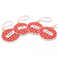 Four personalised red Christmas ornament pendants with white star patterns, red-and-white twine loops, and gold hanging tabs, shown on a white background. The names 'MUMMY', 'DADDY', 'SOPHIA', and 'JESSICA' are printed on white nameplates attached to each ornament.