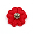 A red felt flower-shaped accessory with a silver metal pin back, shown on a plain white background.